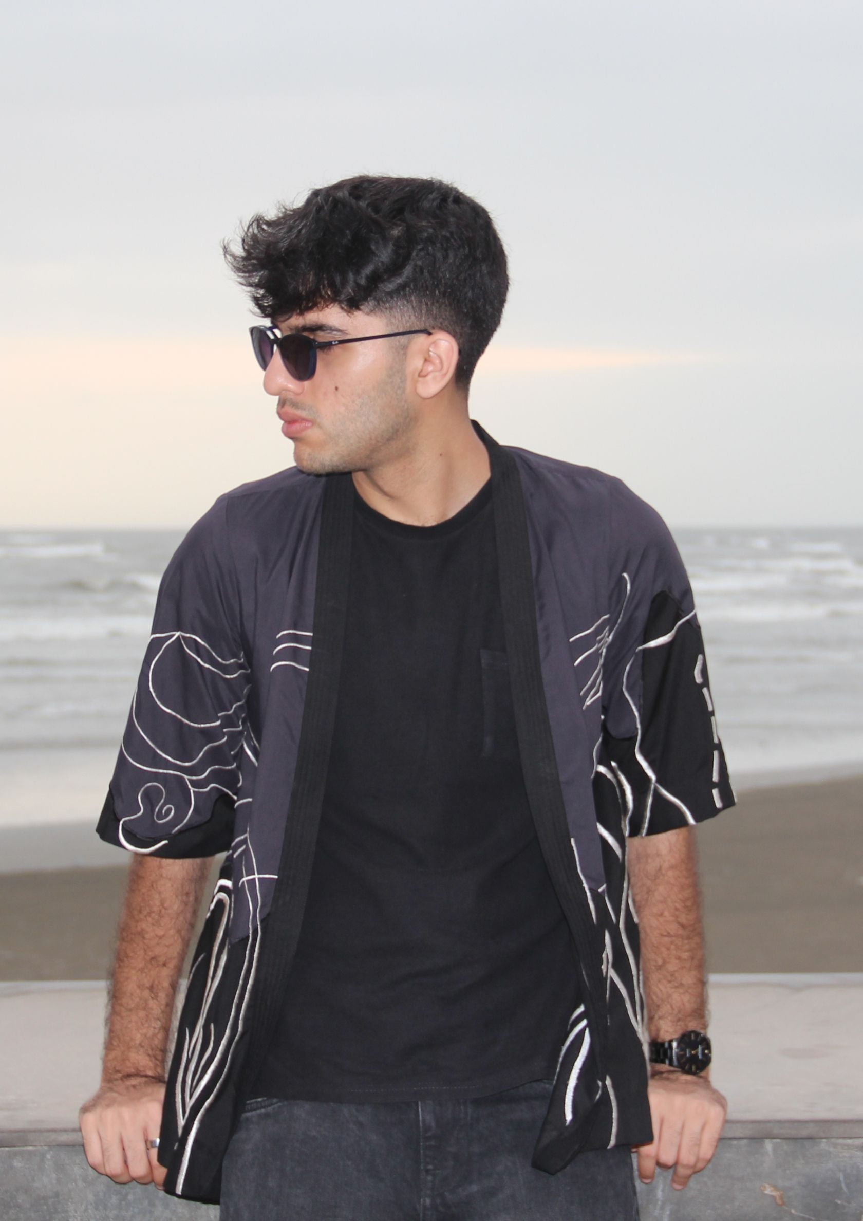 Man wearing Dastaan black, grey, blue and white patterned jacket, kimono, cardigan. Made with Premium Material and Cultural Significance.