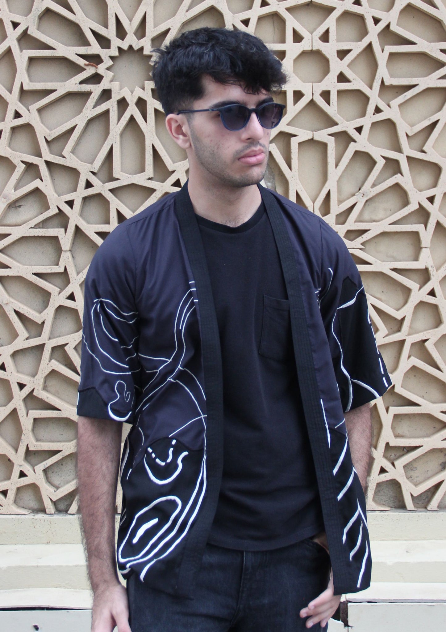 Man wearing Dastaan black, grey, blue and white patterned jacket, kimono, cardigan. Made with Premium Material and Cultural Significance.