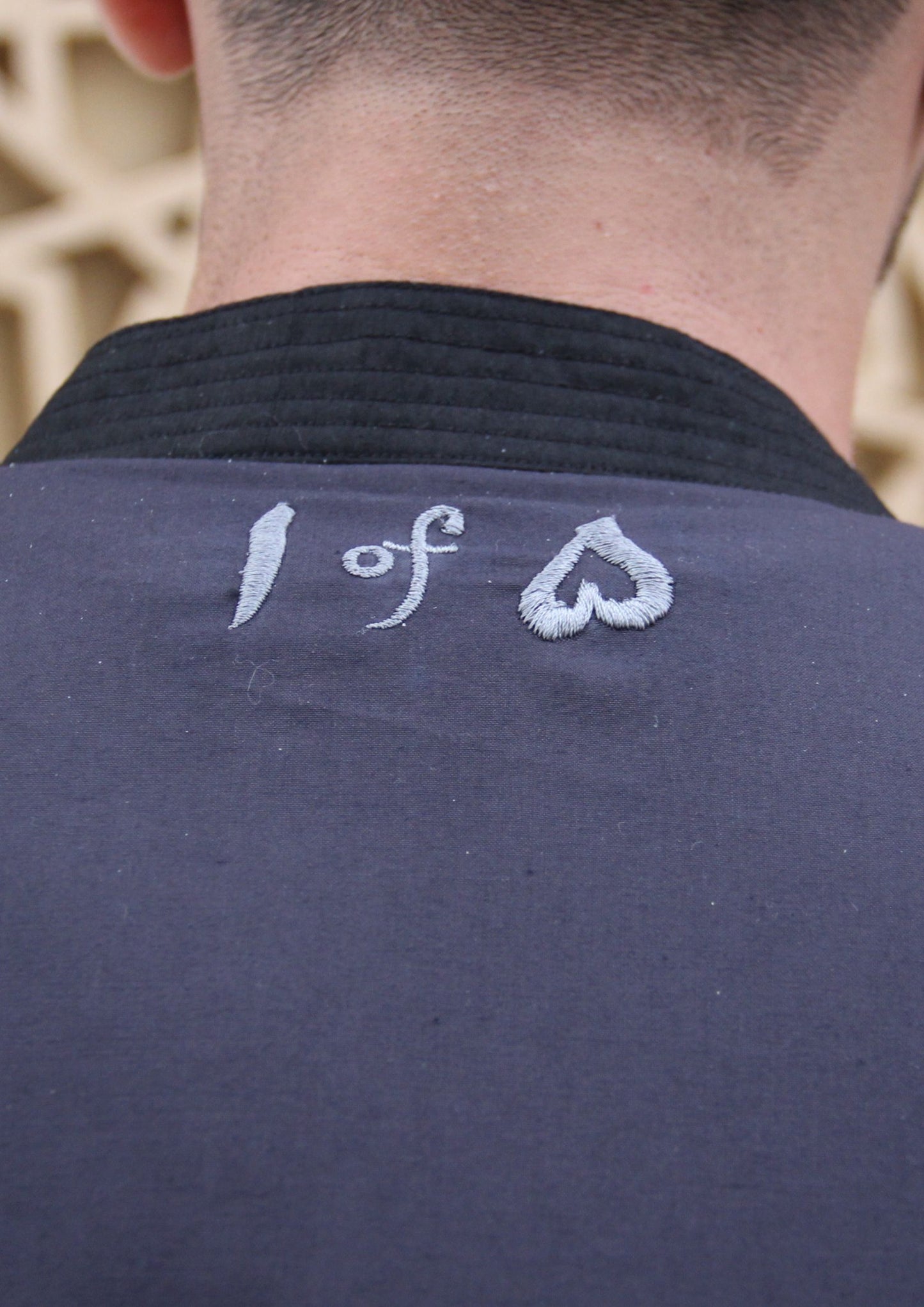 Man wearing Dastaan black, grey, blue and white patterned jacket, kimono, cardigan. Made with Premium Material and Cultural Significance.